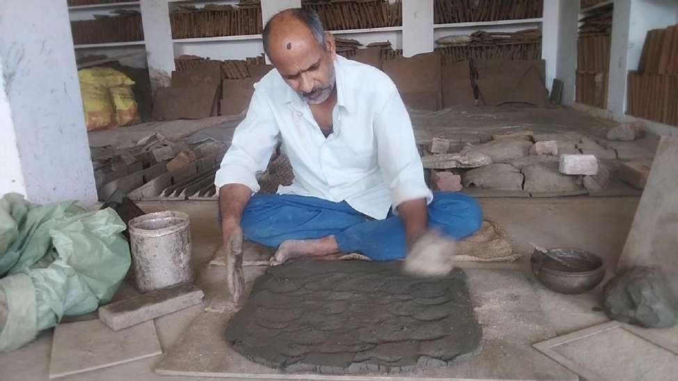 Stage 1: Preparing and kneading the tempered Banas river terracotta clay base on the workshop floor in Molela