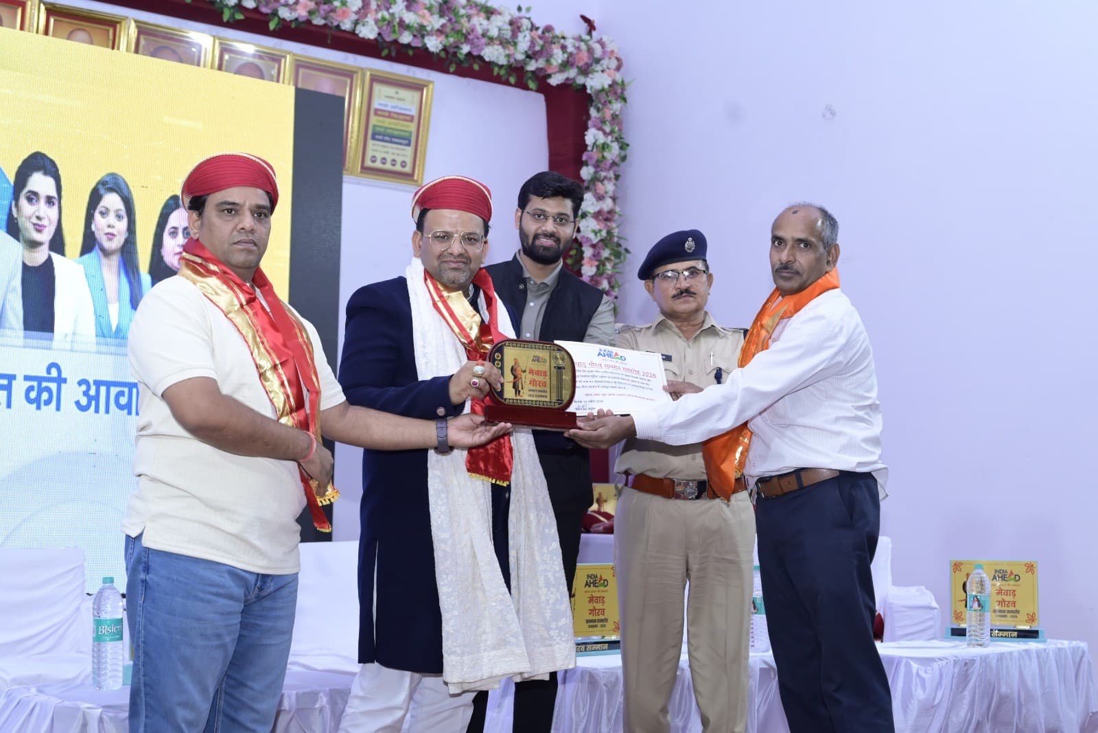 Dinesh Chandra Kumhar receiving the Mewar Gaurav Samman 2024 trophy and certificate on stage