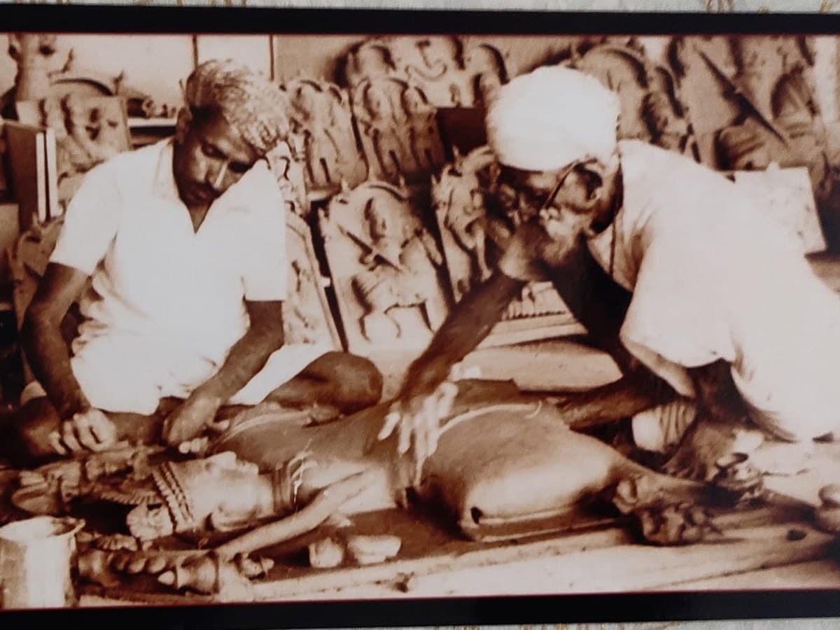 Archival photo of young Mohan Lal Kumhar beside his father Chaturbhuj Kumhar sculpting terracotta plaques in Molela