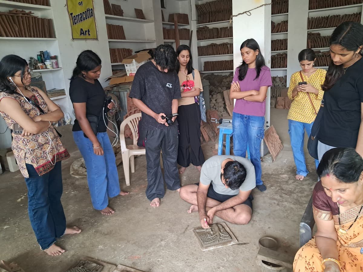 Hands-on terracotta sculpting masterclass guiding design students through Molela clay relief techniques
