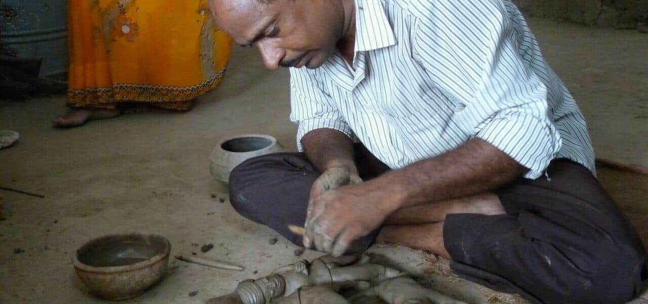 Dinesh Molela demonstrating Molela terracotta clay work at a craft exhibition