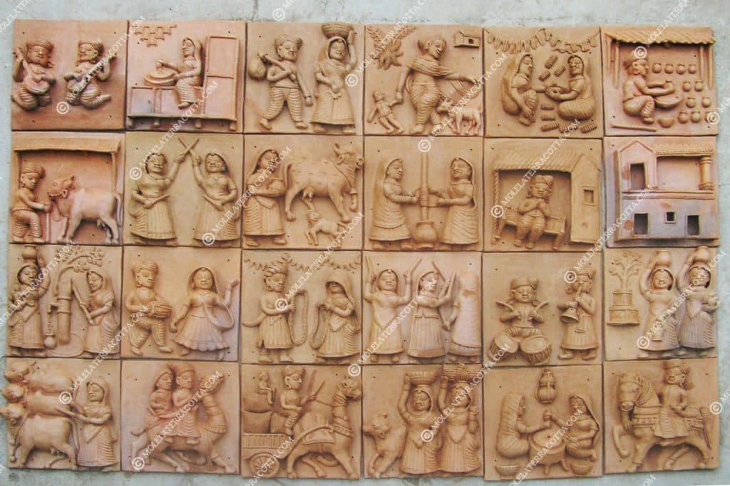 Molela terracotta tile showing a village household scene in clay relief
