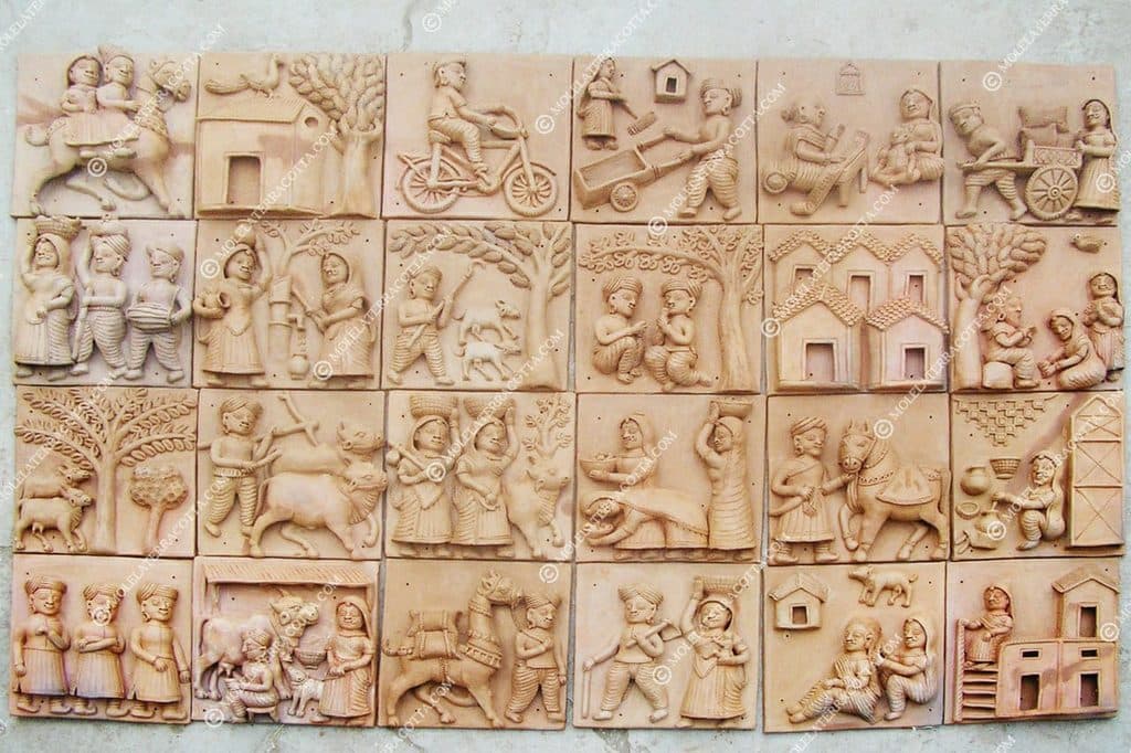 Molela terracotta tile of a farmer with cattle in relief